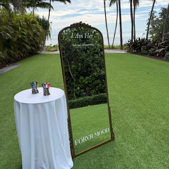 Timeless Welcome Mirror wedding rental in Miami with an ornate gold frame, custom vinyl lettering, and a tropical waterfront setting.